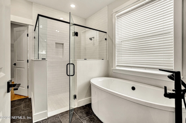 bathroom featuring tile patterned flooring and separate shower and tub