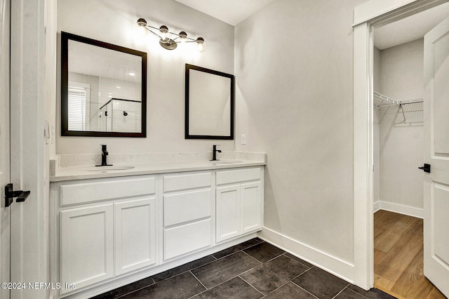 bathroom featuring a shower with door, vanity, and wood-type flooring