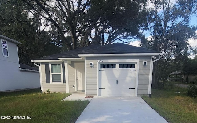 view of front of house with a garage and a front yard