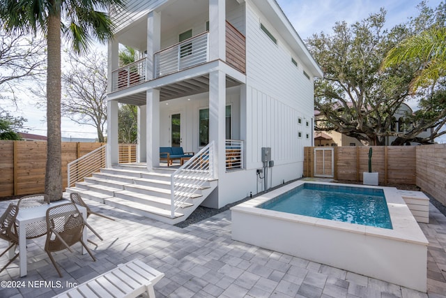 2 Sanchez Cv, Saint Augustine, FL 32080 - rear view of property with board and batten siding, a balcony, a patio area, and a fenced backyard
