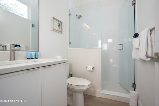 2 Sanchez Cv, Saint Augustine, FL 32080 - full bath with vanity, a stall shower, toilet, wood finished floors, and baseboards