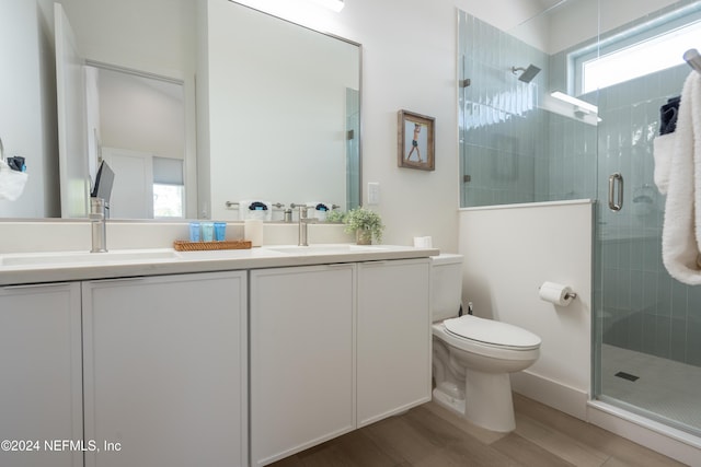 2 Sanchez Cv, Saint Augustine, FL 32080 - full bathroom featuring double vanity, wood finished floors, a shower stall, and toilet