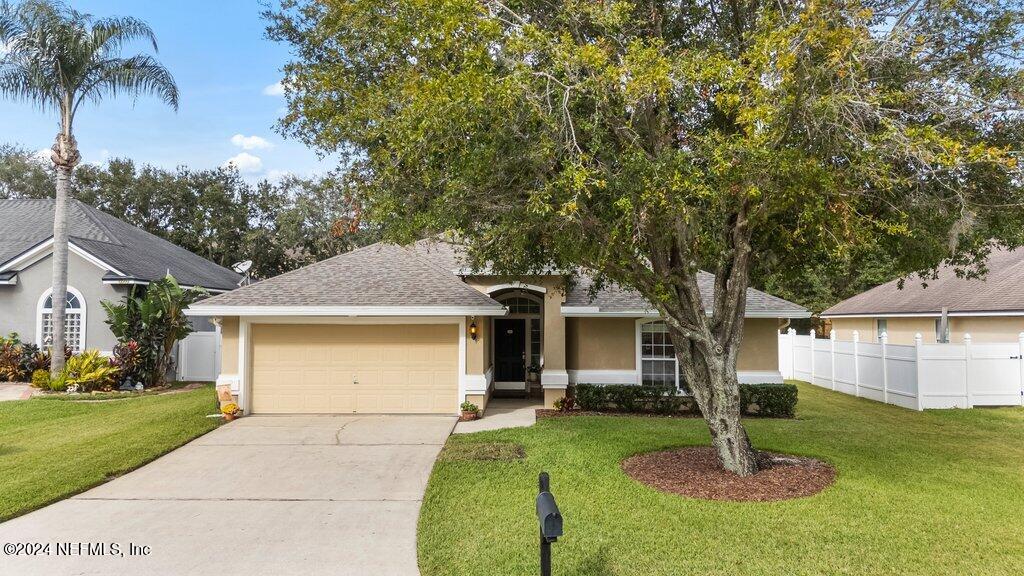 single story home with a front lawn and a garage