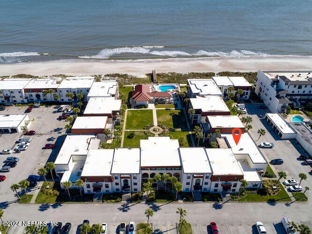 drone / aerial view featuring a view of the beach and a water view