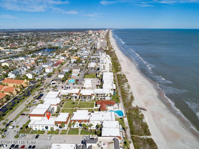 bird's eye view with a water view and a beach view