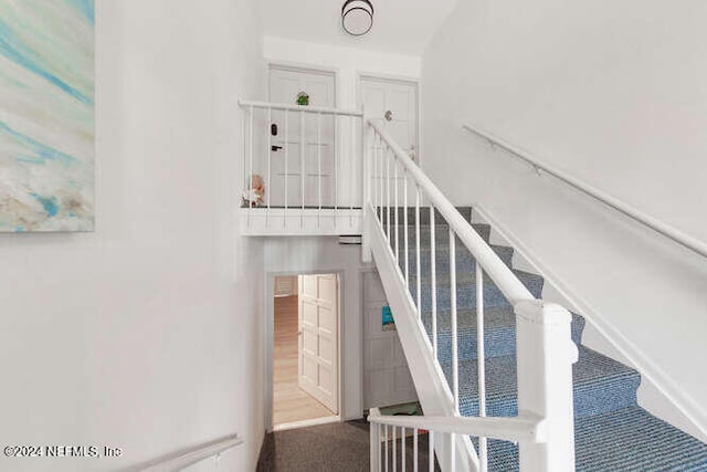 stairs featuring carpet floors and a water view