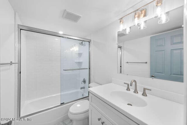 full bathroom featuring vanity, toilet, and enclosed tub / shower combo