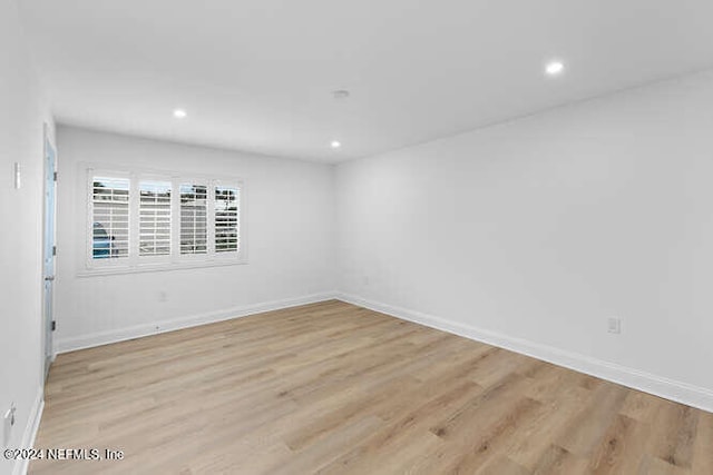 empty room with light hardwood / wood-style flooring