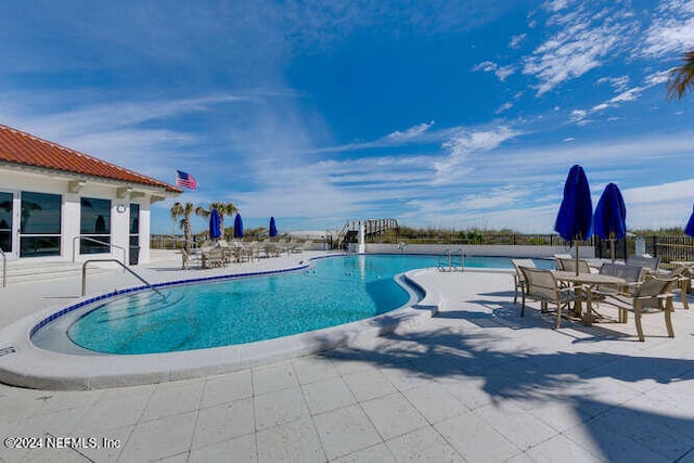 view of swimming pool with a patio