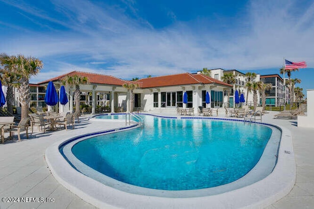 view of swimming pool with a patio area