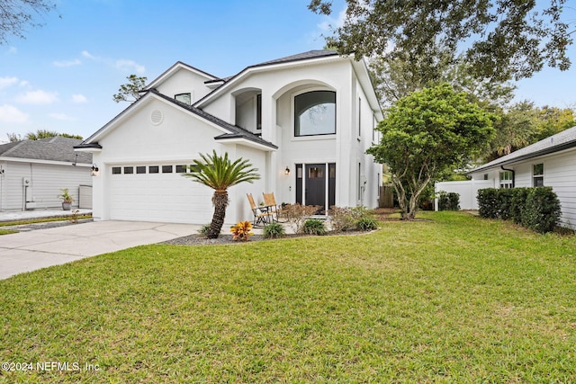 view of front of property featuring a garage and a front lawn