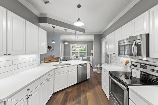 kitchen with appliances with stainless steel finishes, tasteful backsplash, white cabinetry, and sink