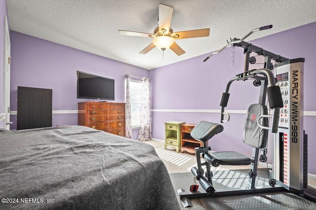 bedroom featuring ceiling fan, carpet floors, and a textured ceiling