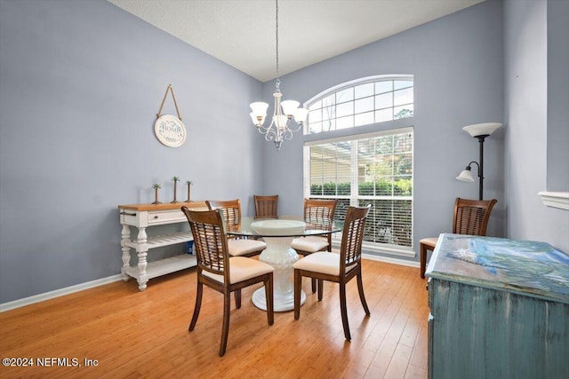 dining room with wood-type flooring and a notable chandelier