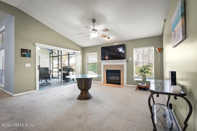 carpeted living room featuring a textured ceiling, ceiling fan, and lofted ceiling