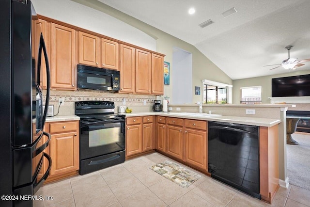 kitchen with tasteful backsplash, kitchen peninsula, lofted ceiling, light tile patterned floors, and black appliances