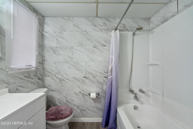 full bathroom with vanity, shower / bath combination with curtain, toilet, tile walls, and wood-type flooring