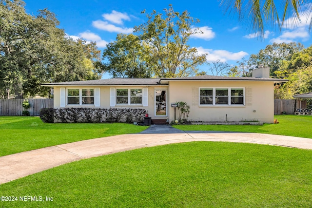 ranch-style home with a front lawn