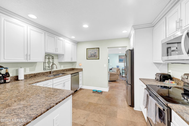 kitchen with sink, white cabinets, and stainless steel appliances