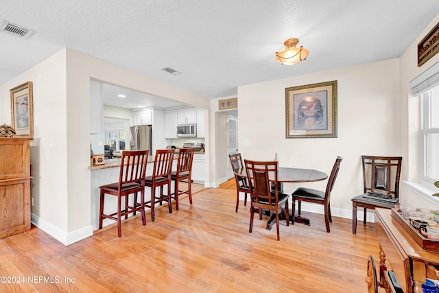 7305 Poinciana St, Jacksonville, FL 32217 - dining area with light wood-type flooring and baseboards