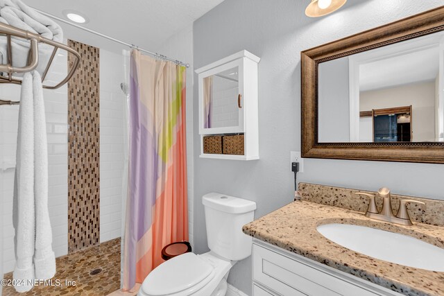 7305 Poinciana St, Jacksonville, FL 32217 - full bathroom with toilet, vanity, and tiled shower