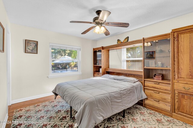 7305 Poinciana St, Jacksonville, FL 32217 - bedroom with light wood-style flooring, ceiling fan, and baseboards