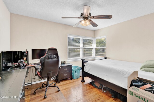 7305 Poinciana St, Jacksonville, FL 32217 - bedroom featuring wood finished floors, a desk, a textured ceiling, and ceiling fan