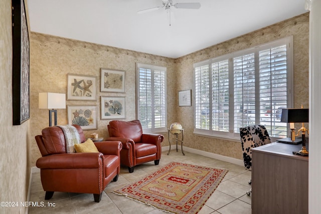 sitting room with ceiling fan and light tile patterned flooring