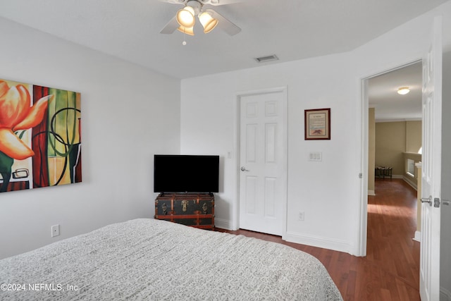 bedroom featuring ceiling fan and dark wood-type flooring