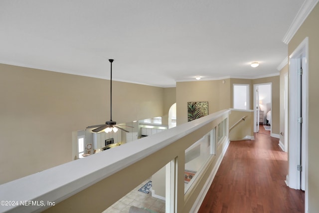 hall with dark hardwood / wood-style flooring and crown molding