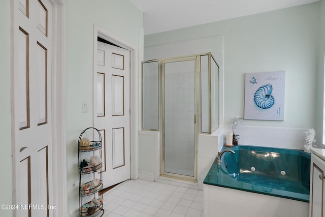 bathroom with tile patterned flooring, vanity, and plus walk in shower