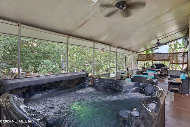 sunroom / solarium featuring ceiling fan, a healthy amount of sunlight, lofted ceiling, and a hot tub