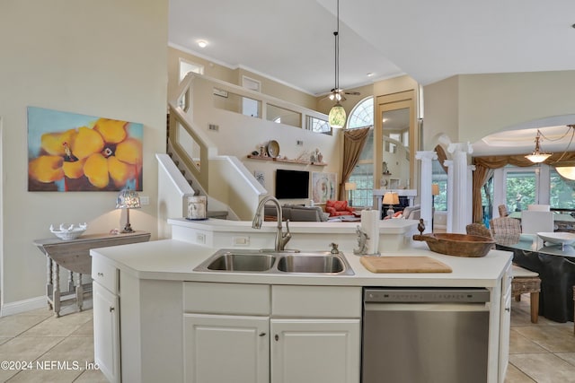 kitchen with ceiling fan, sink, light tile patterned floors, stainless steel dishwasher, and white cabinets