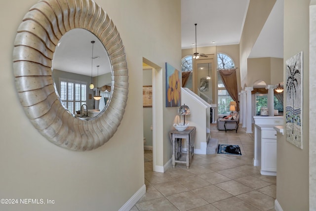 foyer entrance featuring ceiling fan and light tile patterned floors