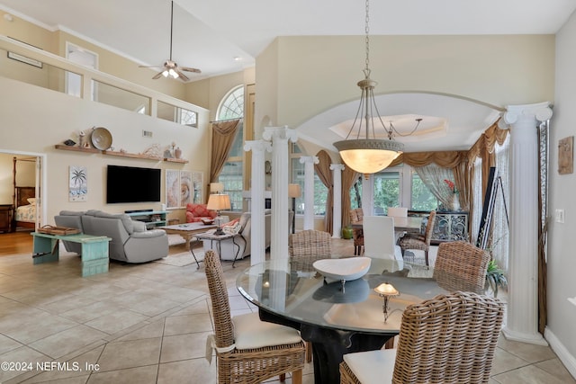 tiled dining area featuring ceiling fan, high vaulted ceiling, and a healthy amount of sunlight