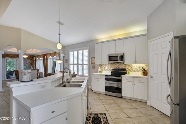 kitchen featuring white cabinets, sink, stainless steel appliances, and a center island with sink