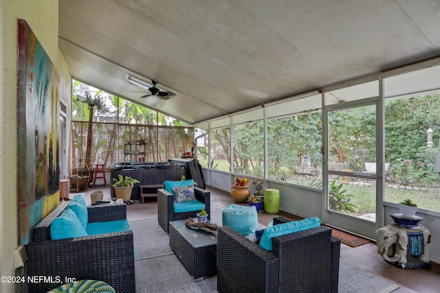 sunroom with ceiling fan and vaulted ceiling