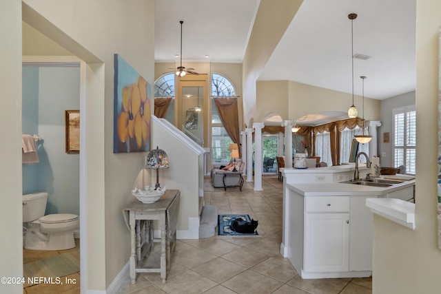 foyer entrance featuring ceiling fan, light tile patterned flooring, and sink