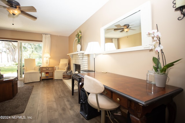 office area with a fireplace, ceiling fan, and hardwood / wood-style floors