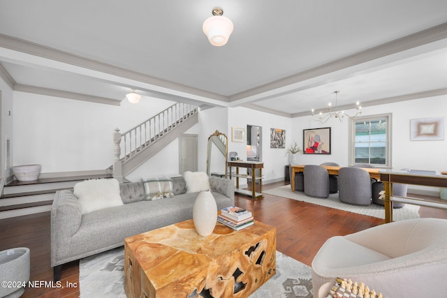 living room with hardwood / wood-style flooring, crown molding, and a notable chandelier