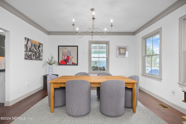 dining space featuring hardwood / wood-style floors, a chandelier, and ornamental molding