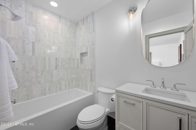 full bathroom featuring vanity, toilet, and tiled shower / bath