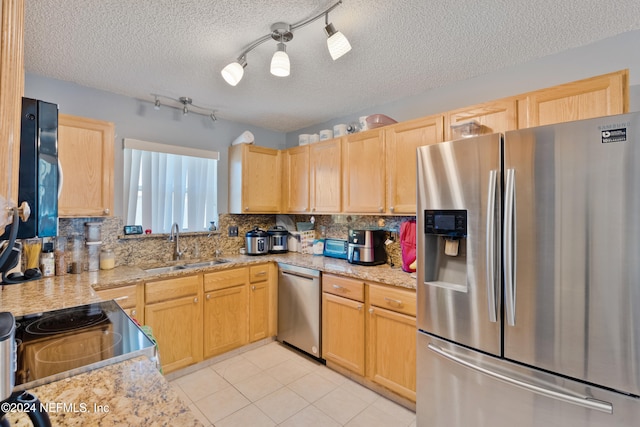 kitchen featuring sink, stainless steel appliances, a textured ceiling, and light brown cabinets