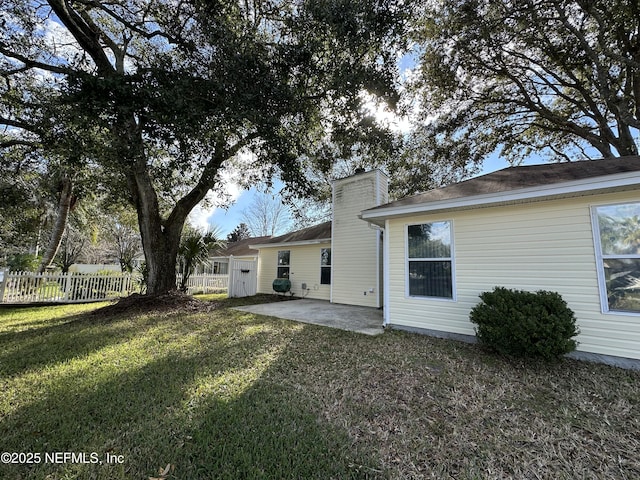 rear view of house featuring a yard and a patio