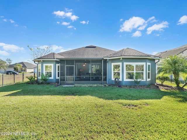 back of house with a yard and a sunroom