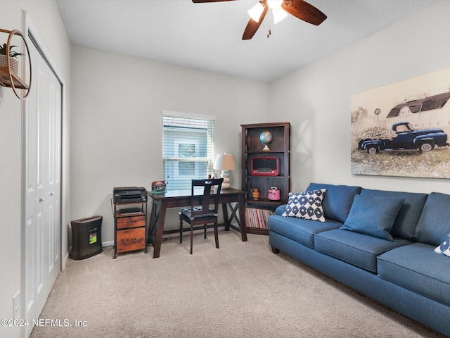 carpeted office featuring ceiling fan