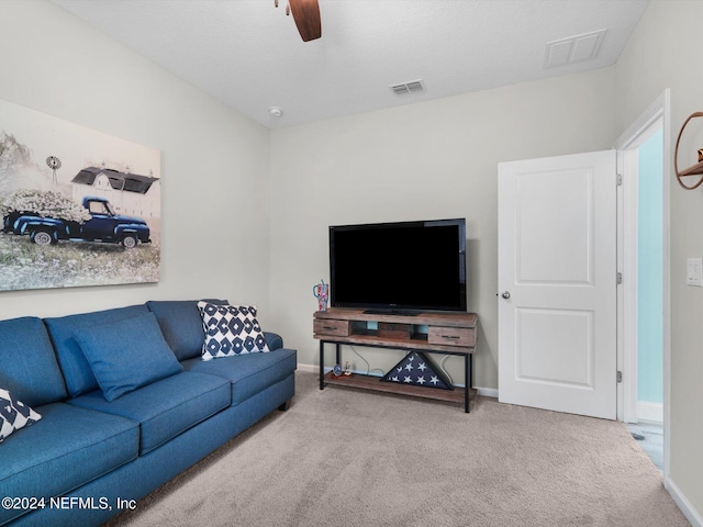 carpeted living room with ceiling fan