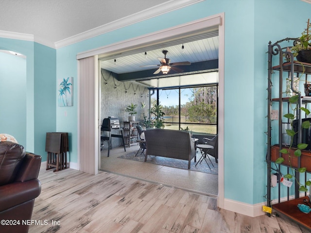 living room featuring light hardwood / wood-style flooring, ceiling fan, and crown molding