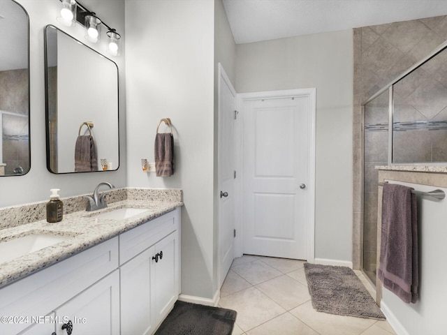 bathroom with tile patterned flooring, vanity, and an enclosed shower