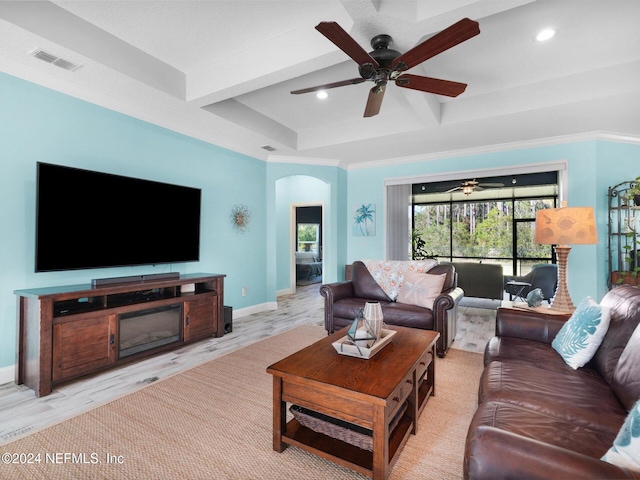 living room with beamed ceiling and light wood-type flooring